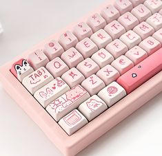 a pink computer keyboard with white keys and pictures on the keypad, sitting on a table