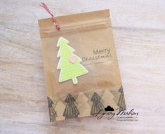 a brown paper bag with a green christmas tree on it