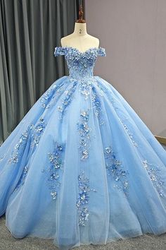 This Elegant Sky Blue Ball Gown is the epitome of grace and luxury, designed to make you feel like royalty on your special day. It is crafted from soft tulle fabric and boasts a voluminous ball gown silhouette, flowing beautifully into an exquisite cathedral train that adds drama and elegance with every step you take. The off-the-shoulder neckline enhances the gown's romantic charm, highlighting the shoulders and collarbones for a timeless and flattering effect. The sweetheart neckline creates a Train Fabric, Blue Ball Gown, Adult Dress, Prom Dresses Sparkly, Quinceanera Dresses Blue, Blue Ball Gowns, Floral Prom Dresses, Cathedral Train, Exquisite Gowns