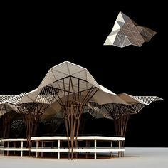 an artistically designed pavilion sits under a black sky