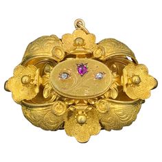 This is a rare and wonderful antique Victorian locket pendant with beautiful Ruby and Rose Cut Diamond adornments in stunning 14 Karat Gold. It is very rare to find antique jeweled Victorian Lockets. This beauty is set with a central flower motif design with a gorgeous natural fine red Ruby in the center and two wonderful Rose Cut Diamonds on either side. The jewels create the flowers and buds of the floral motif. The gold work in this locket is extraordinary. The piece is created with applied l Diamond Locket, Victorian Locket, Rose Diamond, Flower Motif, Gold Work, Neck Chain, Ruby Rose, Gold Flower, Drop Necklace