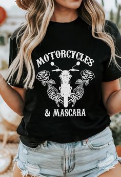 a woman wearing a black shirt that says motorcycles and mascara on the front