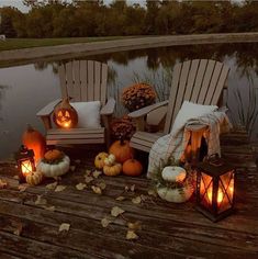 pumpkins and lanterns are sitting on the dock