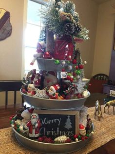 three tiered trays with christmas decorations on the top, and a sign that says merry christmas