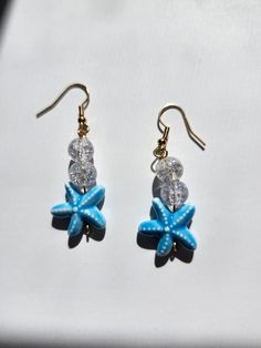 These pretty and blue starfish earrings would go perfect with any beach look or down the shore vacation. Summer Light Blue Pierced Earrings, Handmade Blue Summer Jewelry, Handmade Summer Blue Jewelry, Blue Dangle Earrings With Ocean-inspired Style, Ocean-inspired Blue Dangle Earrings, Blue Star Jewelry For Vacation, Blue Star Shaped Jewelry For Vacation, Blue Ear Wire Earrings For The Beach, Blue Summer Style Jewelry Gift