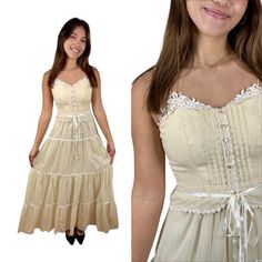 "Lovely 1970s prairie dress by designer Candi Jones.  The fabric is a semi-sheer voile in an ivory color.  The bodice has spaghetti straps that can be re-tied at the shoulder to adjust for fit.  The sweetheart neckline is embellished with white cotton crocheted lace which is also displayed on either side of the button placket and on the edge of the peplum at the waist. There are three pintuck pleats on either side of the buttons, which are petite and pearly. The skirt has four tiers of ruffles s Spring Vintage Lace Dress With Lace Work, Vintage Cream Prairie Dress For Summer, Vintage Summer Maxi Dress With Lace Trim, Cream Prairie Dress With Lace Trim For Daywear, Vintage Beige Prairie Dress With Lace Trim, Fitted Cream Prairie Dress Cottagecore Style, Fitted Cream Prairie Dress For Summer, Vintage Beige Prairie Dress For Spring, Cottagecore Cream Prairie Dress For Garden Party