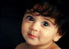 a close up of a young child with blue eyes