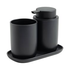 two black cups and saucers sitting on a tray next to each other in front of a white background