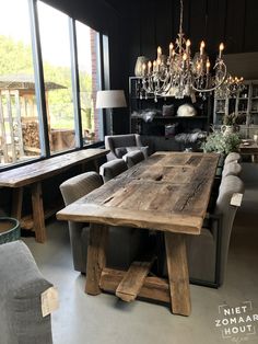 a large wooden table sitting inside of a living room