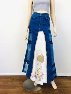 Vintage 1970s Patchwork Denim Maxi Skirt - high waisted - pockets with button closures - made from from french dip bell bottom jeans w/ patchwork waistbands - embroidered tablecloth with floral design, front & back - crochet trim - zipper fly Great vintage condition appx size - S 26 waist 36 hip 42.5 length / little longer at front All sales are final / as-is. We do not accept returns. Fitted Denim Hippie Bottoms, Hippie Fitted Denim Bottoms, Vintage Patchwork Bottoms, Retro Denim Bottoms For Festival, Vintage Denim Skirt In Denim Blue, Retro Medium Wash Cotton Skirt, Vintage Medium Wash Skirt With Pockets, Vintage High-rise Skirt With Pockets, Vintage High-waisted Denim Blue Skirt