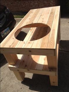 a wooden bench sitting on top of a sidewalk