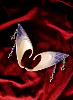 These stunning dragon elf ears feature handmade dangling purple and green earrings and hand painted dragon scales package includes 1 pair of elf ears Painted Elf Ears, Cosplay Elf Ears, Dragon Elf, Fae Cosplay, Larp Outfit, Fantasy Cottagecore, Cosplay Elf, Cottagecore Accessories, Painted Dragon