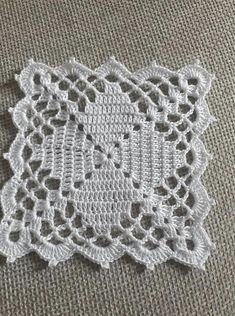 crocheted placemats are sitting on top of a tablecloth with white thread