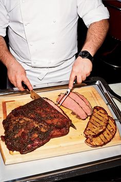 a chef is cutting up some meat on a board