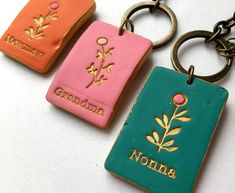 three different colored key chains with the name grandma on one and grandma on the other