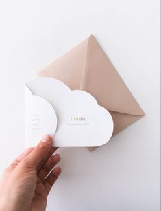 someone is holding up some business cards in front of an envelope with the word lefome on it