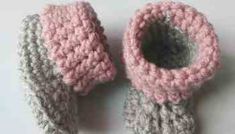 two crocheted baby booties sitting next to each other