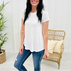 Made With Extra Soft, Flowy, And Stretchy Material, This Crewneck Top Is Perfect For Layering Or Wearing On Its Own All Year Long. Its Versatile Design Allows You To Dress It Up Or Down. Don't Miss Out On This Wardrobe Essential! Style This Top With Shorts And Sandals For An Easy Everyday Look, Or Change It Up And Wear It Under A Shacket With Jeans And Sneakers! Materials: 95% Rayon 5% Spandex White Short Sleeve Top For Layering, White Shirttail Hem Top For Spring, White Short Sleeve Top, Relaxed Fit For Day Out, White Stretch Short Sleeve Top, Trendy White Top For Layering, White Relaxed Fit Top With Shirttail Hem, White Relaxed Fit Short Sleeve Top For Day Out, White Tops With Relaxed Fit And Shirttail Hem, White Relaxed Fit Tops With Shirttail Hem