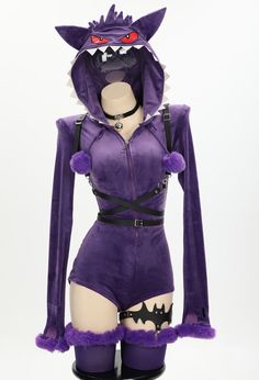 a woman in purple is wearing a costume with an animal head on it's chest