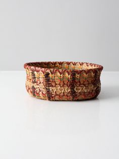 a woven basket sitting on top of a white table