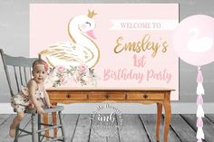 a baby sitting on a chair in front of a birthday sign and balloon with the words welcome to emsley's 1st birthday party