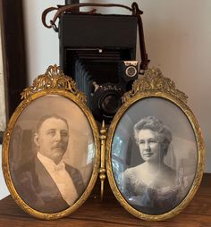 an old fashioned camera with two pictures in front of it