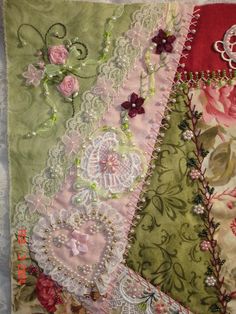 a close up of a piece of fabric with flowers and laces on it's edges