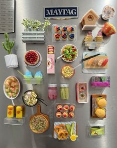 many different types of food are arranged on the refrigerator door, including fruit and vegetables