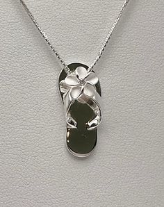 "Solid .925 Sterling Silver Hawaiian Plumeria Pua Melia Slipper pendant. VERY pretty and highly-detailed design in person. The size is 20MMx8MM, about 3/4\" long. FREE Sterling Silver Italian box chain included in your choice of length. --The Plumeria on the Slippers strap has a matte finish with high-polished shiny edges. It has a tiny cubic zirconia in the center for a touch of sparkle. --Packaged ready for gifting with two Hawaiian Plumeria Stories, Sterling silver cleaning instructions, a bo Silver Slippers, Whale Tail Necklace, Hawaiian Necklace, Hawaiian Plumeria, Hawaii Jewelry, Hawaiian Jewelry, Beach Jewelry, Flower Necklace, Flower Jewellery