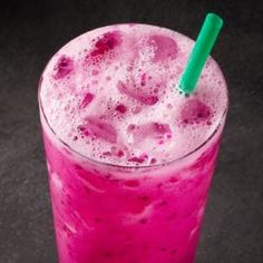 a pink drink with a green straw in it