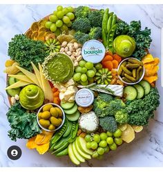 an assortment of fruits and vegetables arranged on a platter