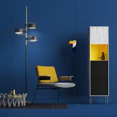 a blue room with a yellow chair and a bird on the wall next to it