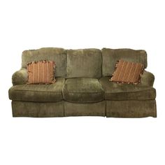 a green couch with two pillows on it