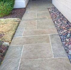 an entrance to a house with gravel and rocks