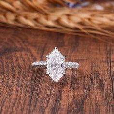 a diamond ring sitting on top of a wooden table