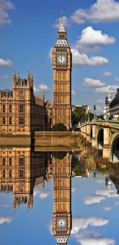 the big ben clock tower towering over the city of london reflected in the river thames