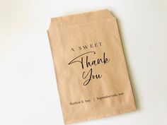 a brown paper bag that says, a sweet thank you with black writing on it