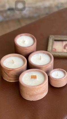 four small candles sitting on top of a table