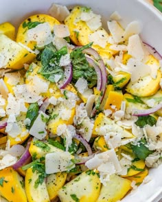 a white bowl filled with vegetables and cheese