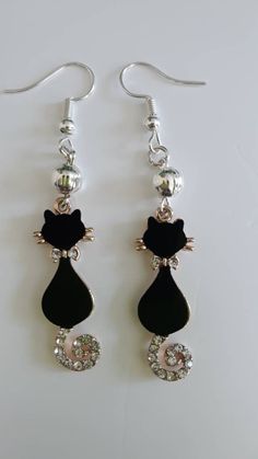 Stunning Black Cat Dangle Earrings  Crystal Tail and Bow Detail Purrfect for the cat lover in your life Black Cat Earrings, Earrings With Crystals, Earrings Crystal, Glasses Chain, Cat Jewelry, Pink Beads, Cat Earrings, Bead Jewellery, Fun Earrings