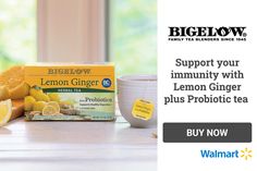 a box of lemon ginger tea sits on a table next to some sliced lemons