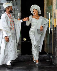 a man and woman dressed in traditional african clothing