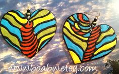 These earrings are hand painted with acrylic paints on lightweight wood and glossed with a clear gloss for protection.. Ear hooks are stainless steel Size 2.5 in long Artistic Handmade Heart Earrings For Gift, Artistic Earrings For Festivals, Handmade Multicolor Bohemian Heart Earrings, Bohemian Multicolor Handmade Heart Earrings, Afro Earrings, Peace Earrings, Africa Earrings, Hair Earrings, Queen Earrings