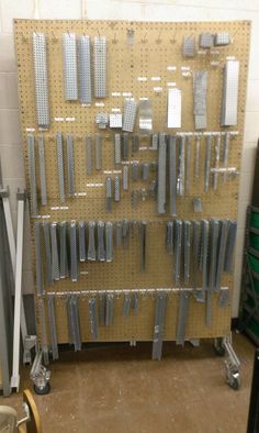 there are many metal pieces on the pegboard