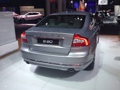 the rear end of a silver car on display