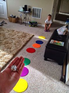 a child sitting on the floor playing with colored circles