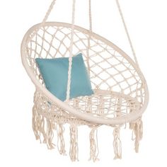 a white hanging chair with a blue pillow on the front and back side of it