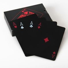 four playing cards are sitting on top of each other in front of a white background