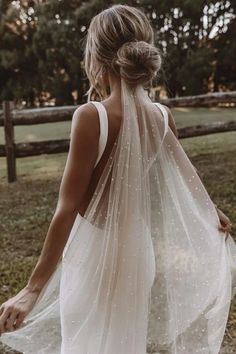 the back of a woman's dress with white dots on it