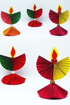 four different colored paper fan shaped candles on white background with red, yellow and green flame